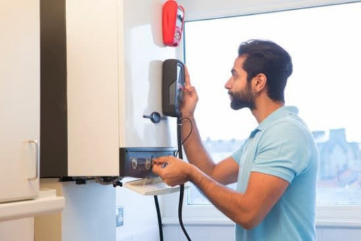 Engineer Servicing Central Heating Boiler